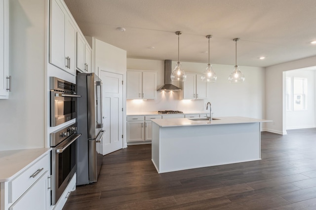 11452 Queens Ct N, Lake Elmo, MN 55042 - kitchen with wall chimney exhaust hood, a sink, appliances with stainless steel finishes, white cabinets, and dark wood finished floors