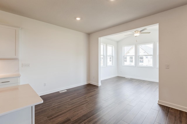 11452 Queens Ct N, Lake Elmo, MN 55042 - unfurnished dining area with ceiling fan, dark wood-style flooring, baseboards, recessed lighting, and vaulted ceiling