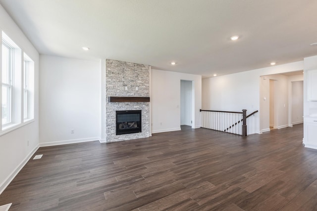 11452 Queens Ct N, Lake Elmo, MN 55042 - unfurnished living room with dark wood finished floors, baseboards, a stone fireplace, and recessed lighting