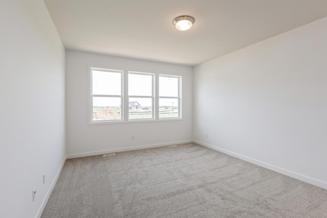 11452 Queens Ct N, Lake Elmo, MN 55042 - spare room featuring light carpet and baseboards