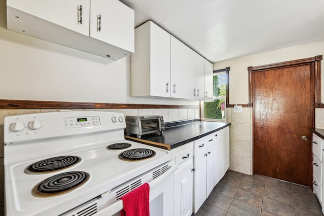 926 Bellows St, West Saint Paul, MN 55118 - kitchen featuring white electric range, white cabinets, dark countertops, and tile walls