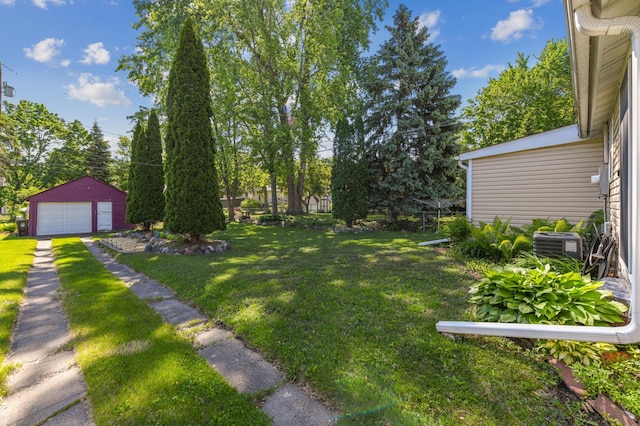 926 Bellows St, West Saint Paul, MN 55118 - view of grassy yard with an outbuilding, a detached garage, and central AC