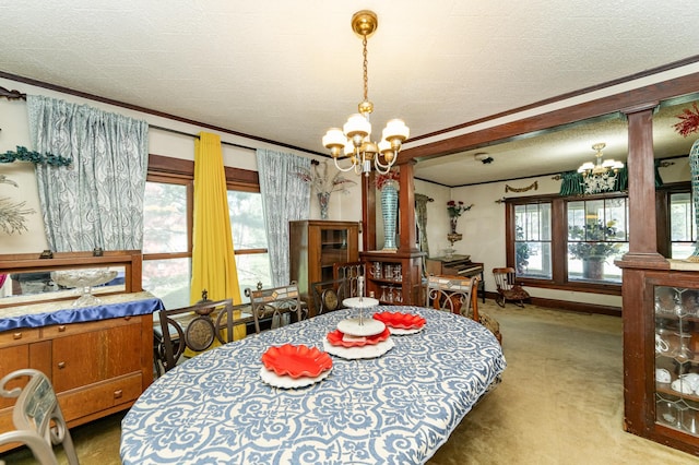 339 Cherry St E, Mazeppa, MN 55956 - carpeted dining space with ornamental molding, decorative columns, a chandelier, baseboards, and a textured ceiling