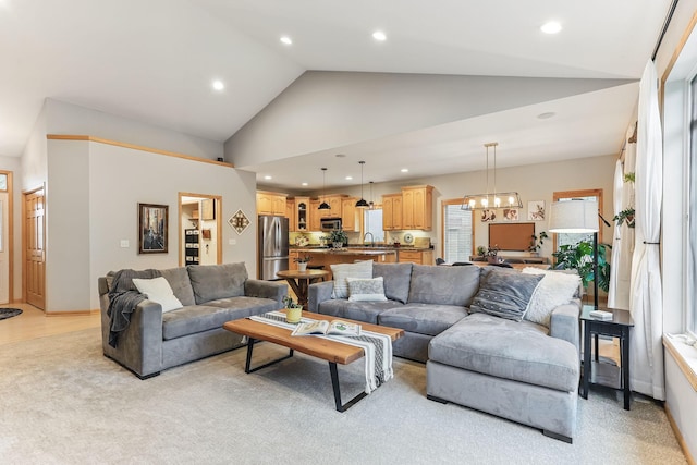 4828 Mason Ave NE, Saint Michael, MN 55376 - living room featuring a chandelier, recessed lighting, light colored carpet, high vaulted ceiling, and baseboards