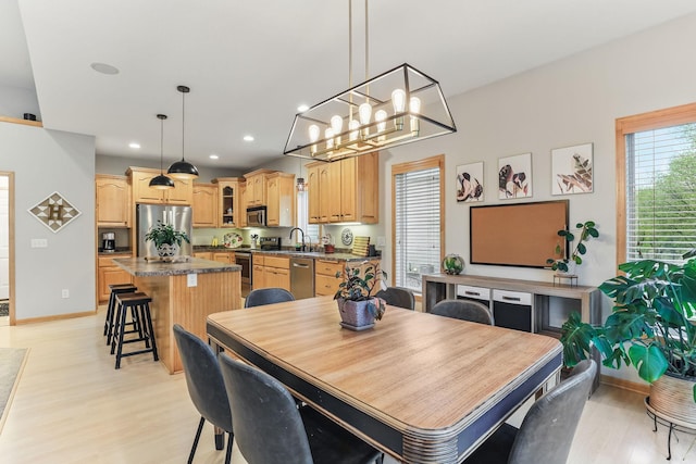4828 Mason Ave NE, Saint Michael, MN 55376 - dining space featuring light wood-style flooring, recessed lighting, a chandelier, and baseboards