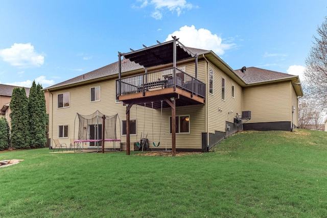 4828 Mason Ave NE, Saint Michael, MN 55376 - back of property with a trampoline, a lawn, and a wooden deck