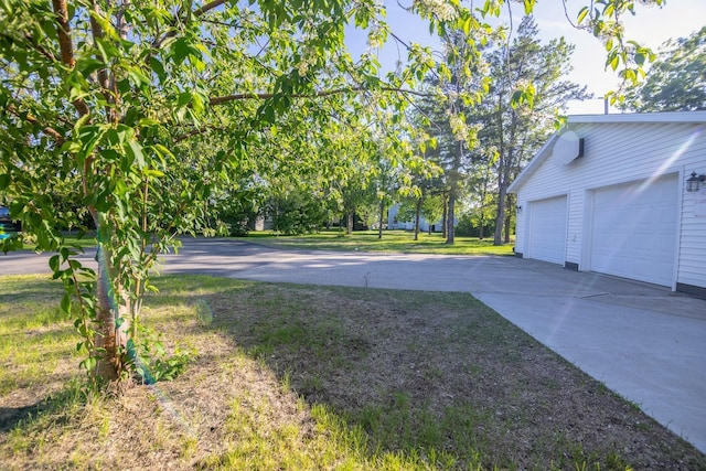 546 2nd St SE, Perham, MN 56573 - view of grassy yard with a garage and driveway