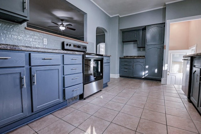 546 2nd St SE, Perham, MN 56573 - kitchen featuring decorative backsplash, a ceiling fan, light tile patterned floors, stainless steel electric stove, and arched walkways