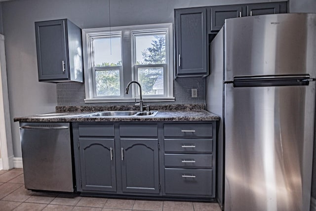 546 2nd St SE, Perham, MN 56573 - kitchen featuring appliances with stainless steel finishes, dark countertops, a sink, and light tile patterned floors