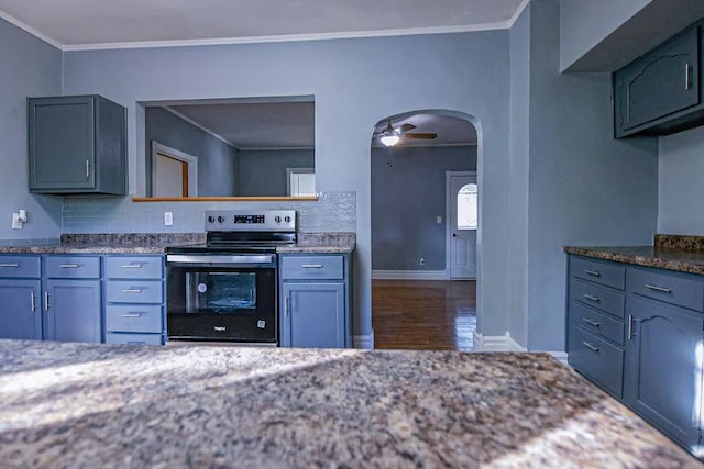 546 2nd St SE, Perham, MN 56573 - kitchen featuring electric range, arched walkways, wood finished floors, tasteful backsplash, and ornamental molding