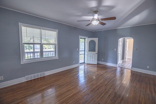 546 2nd St SE, Perham, MN 56573 - spare room with arched walkways, a ceiling fan, crown molding, dark wood-style floors, and baseboards