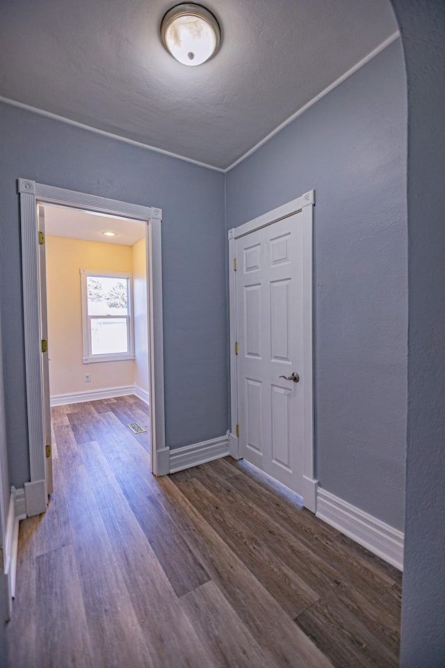 546 2nd St SE, Perham, MN 56573 - empty room with arched walkways, wood finished floors, baseboards, and a textured ceiling