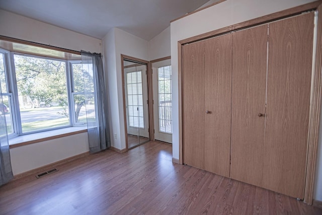 546 2nd St SE, Perham, MN 56573 - unfurnished bedroom featuring light wood-style floors and multiple windows