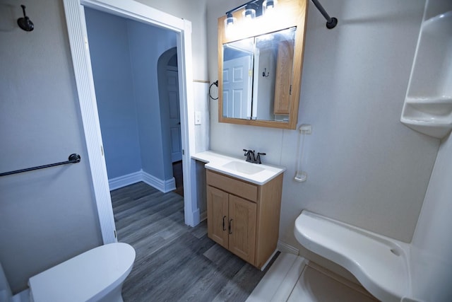 546 2nd St SE, Perham, MN 56573 - bathroom with toilet, wood finished floors, vanity, and baseboards