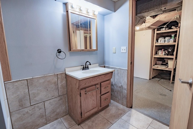 546 2nd St SE, Perham, MN 56573 - bathroom featuring tile walls, wainscoting, and vanity