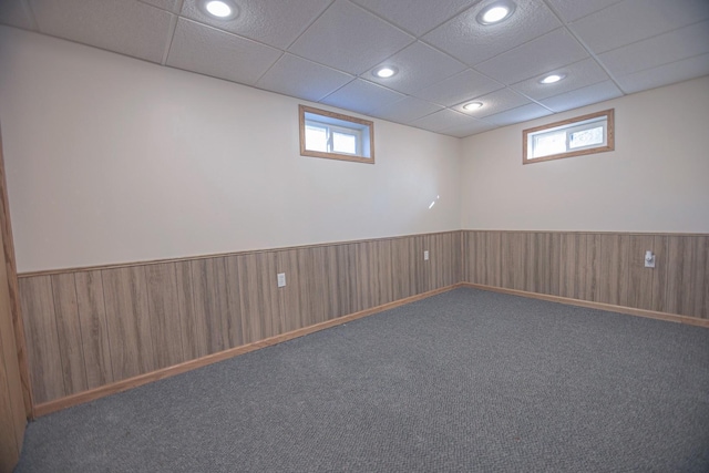 546 2nd St SE, Perham, MN 56573 - carpeted empty room featuring wainscoting, a drop ceiling, and wooden walls