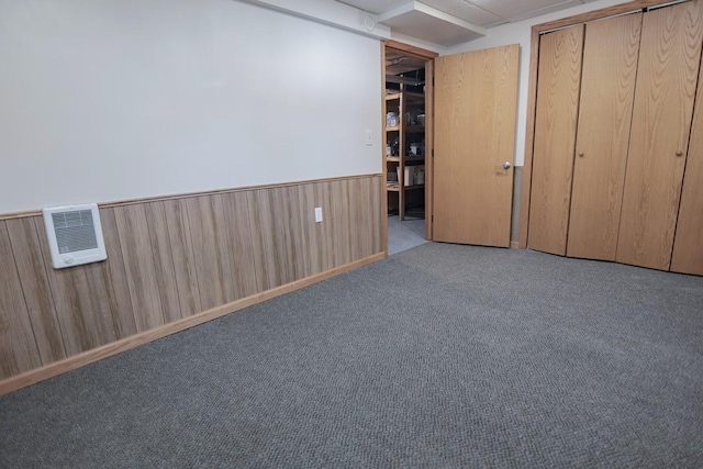546 2nd St SE, Perham, MN 56573 - unfurnished bedroom featuring a wainscoted wall, a closet, carpet flooring, and wooden walls