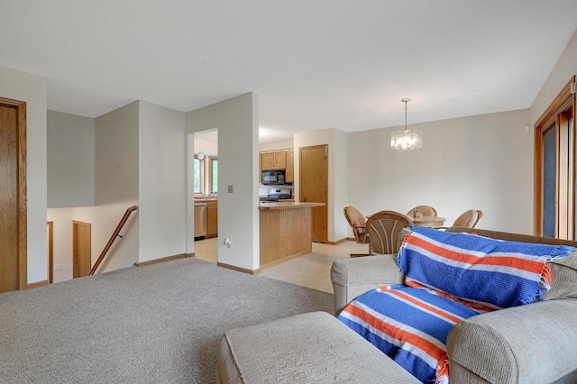 living area with a chandelier and baseboards