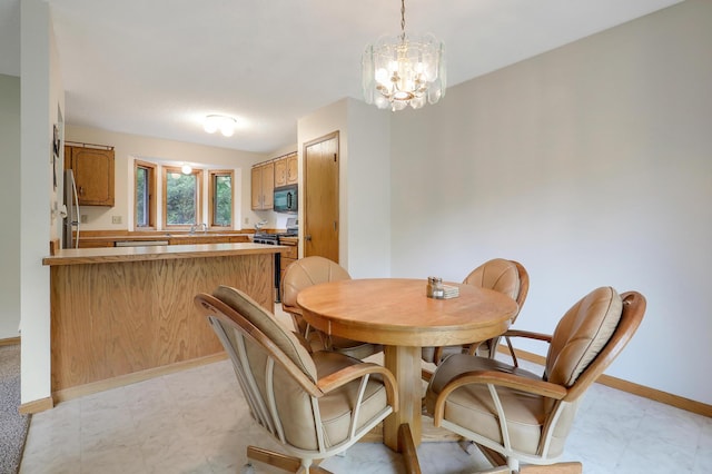 dining space featuring baseboards and a chandelier