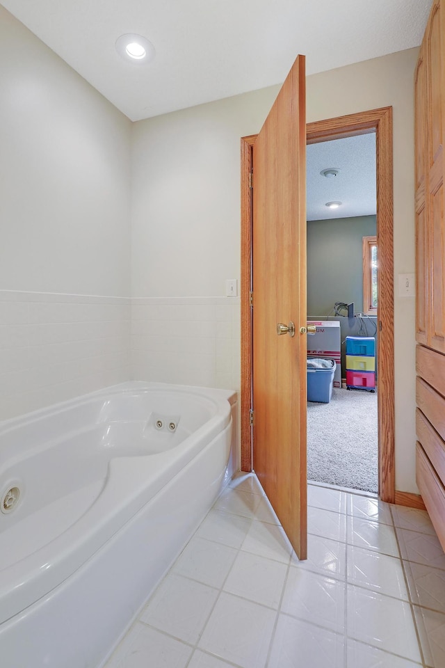 bathroom with a jetted tub, tile patterned floors, and recessed lighting