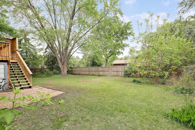 view of yard with stairway and a wooden deck