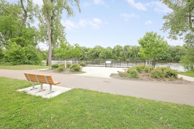 view of home's community featuring a water view and view of wooded area