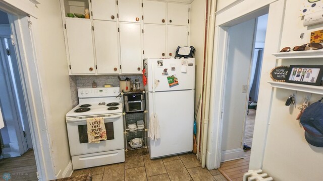 728 8th St N, Fargo, ND 58102 - kitchen with white appliances, white cabinetry, tasteful backsplash, and baseboards