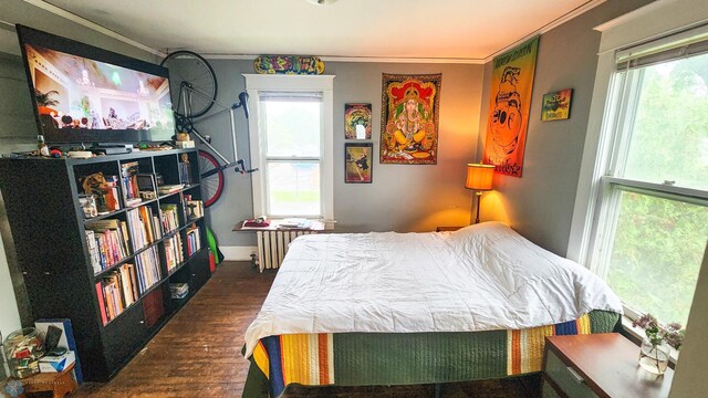 728 8th St N, Fargo, ND 58102 - bedroom with ornamental molding, radiator heating unit, wood finished floors, and baseboards