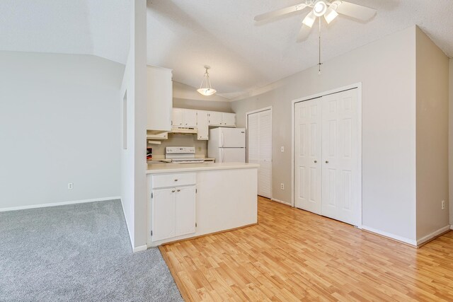 2245 Pinehurst St, Stillwater, MN 55082 - kitchen with white appliances, a peninsula, a ceiling fan, baseboards, and white cabinetry