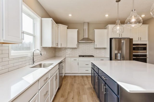 14965 105th Pl N, Maple Grove, MN 55369 - kitchen featuring appliances with stainless steel finishes, wall chimney range hood, a sink, white cabinets, and recessed lighting