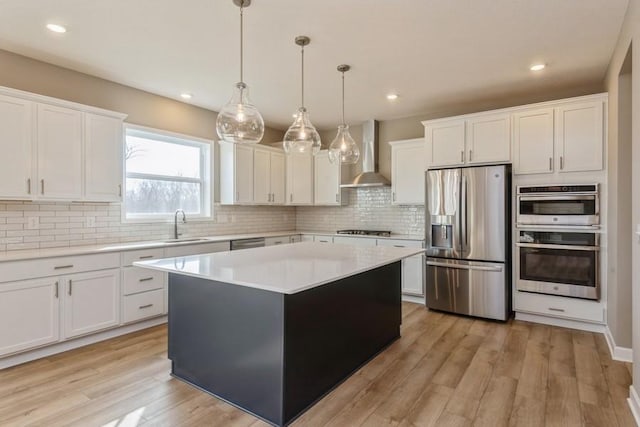 14965 105th Pl N, Maple Grove, MN 55369 - kitchen featuring appliances with stainless steel finishes, wall chimney range hood, light wood finished floors, light countertops, and backsplash