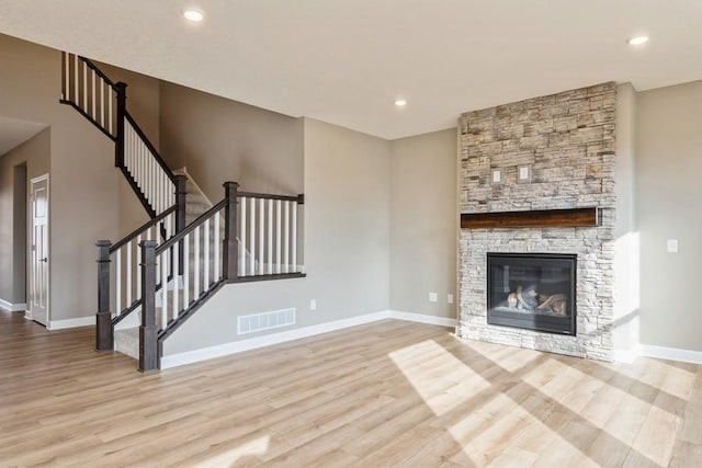 14965 105th Pl N, Maple Grove, MN 55369 - unfurnished living room with wood finished floors, baseboards, a fireplace, and recessed lighting