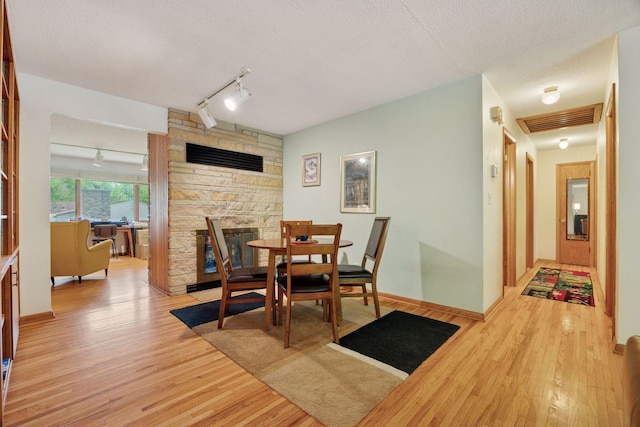 5 Hillside Ct, Northfield, MN 55057 - dining area with rail lighting, light wood-style floors, and a textured ceiling