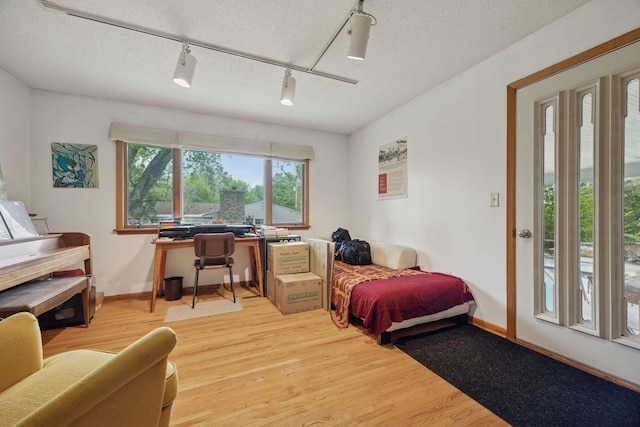 5 Hillside Ct, Northfield, MN 55057 - bedroom with rail lighting, light wood finished floors, a desk, and baseboards