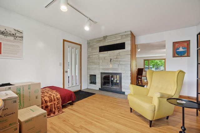 5 Hillside Ct, Northfield, MN 55057 - living room with a stone fireplace, wood finished floors, and rail lighting