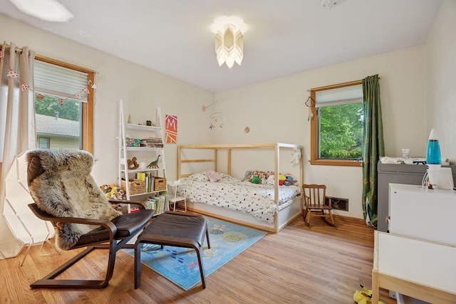 5 Hillside Ct, Northfield, MN 55057 - bedroom with multiple windows, wood finished floors, and baseboards