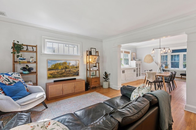 1310 Fairmount Ave, Saint Paul, MN 55105 - living area featuring a chandelier, crown molding, and light wood-style floors