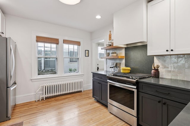 1310 Fairmount Ave, Saint Paul, MN 55105 - kitchen with radiator heating unit, stainless steel appliances, baseboards, backsplash, and recessed lighting