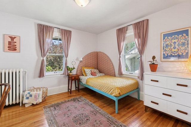 1310 Fairmount Ave, Saint Paul, MN 55105 - bedroom featuring radiator, light wood-style flooring, and baseboards
