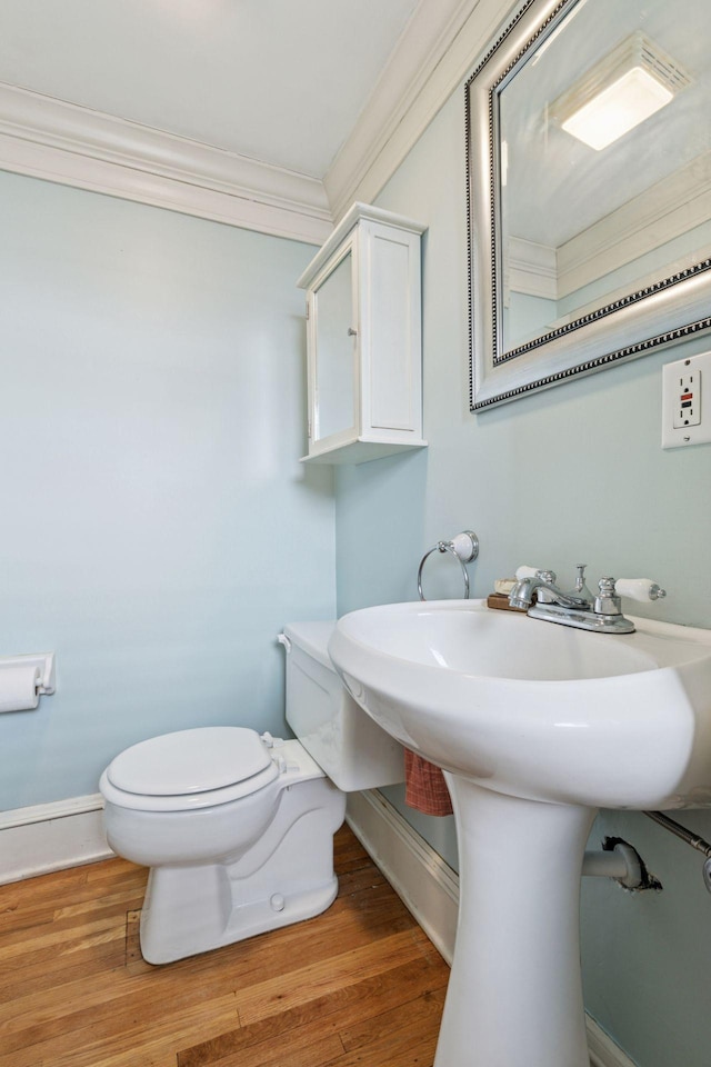 1310 Fairmount Ave, Saint Paul, MN 55105 - half bathroom with baseboards, toilet, ornamental molding, and wood finished floors