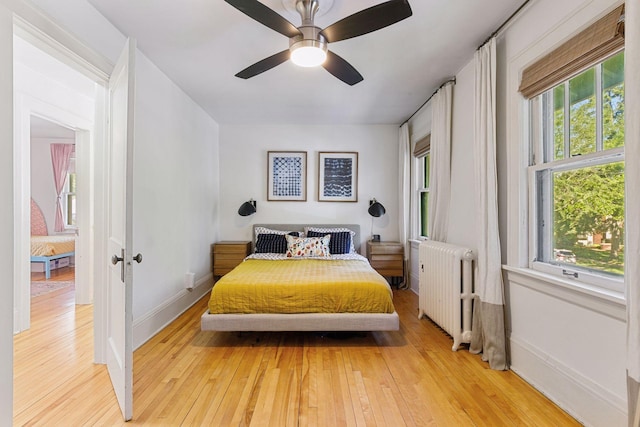 1310 Fairmount Ave, Saint Paul, MN 55105 - bedroom with radiator, light wood-type flooring, ceiling fan, and baseboards