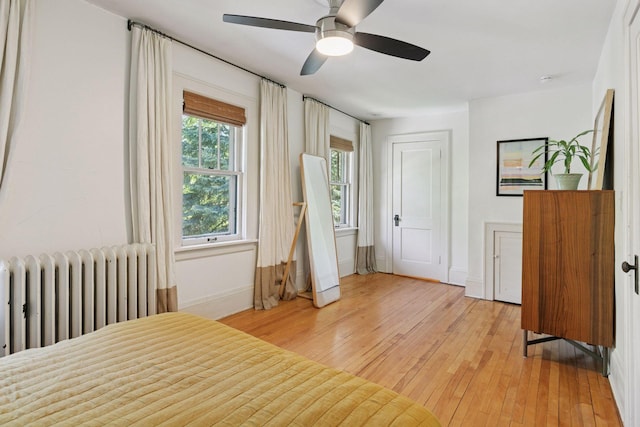 1310 Fairmount Ave, Saint Paul, MN 55105 - bedroom featuring radiator, light wood-style flooring, ceiling fan, and baseboards