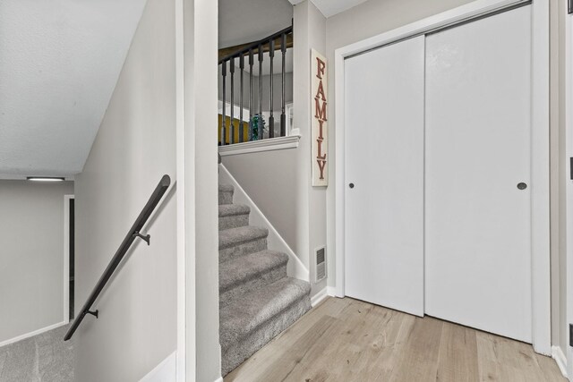 228 16th Ave SW, New Brighton, MN 55112 - stairway featuring wood finished floors and baseboards