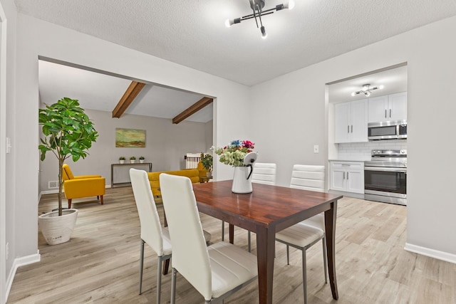 228 16th Ave SW, New Brighton, MN 55112 - dining space featuring light wood-style floors, beamed ceiling, baseboards, and a textured ceiling