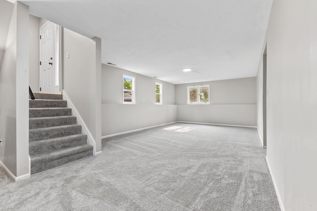 228 16th Ave SW, New Brighton, MN 55112 - basement featuring carpet flooring, stairway, and baseboards