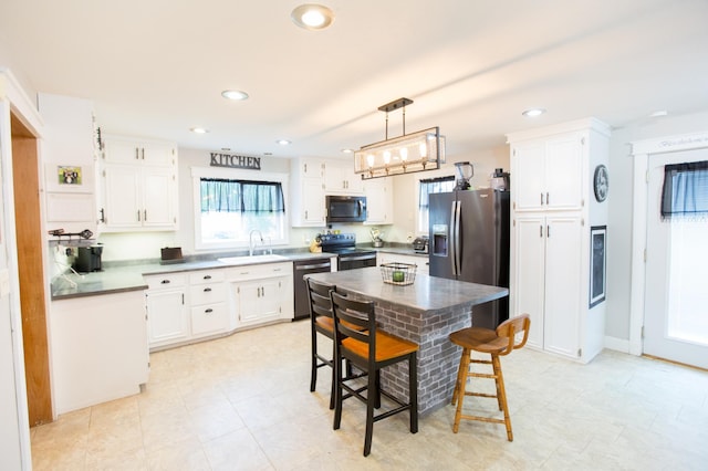 2758 220th St, Madison, MN 56256 - kitchen with stainless steel appliances, a sink, white cabinets, recessed lighting, and pendant lighting