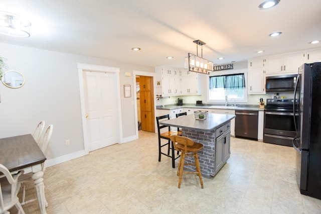 2758 220th St, Madison, MN 56256 - kitchen featuring stainless steel appliances, a kitchen bar, white cabinetry, a center island, and recessed lighting