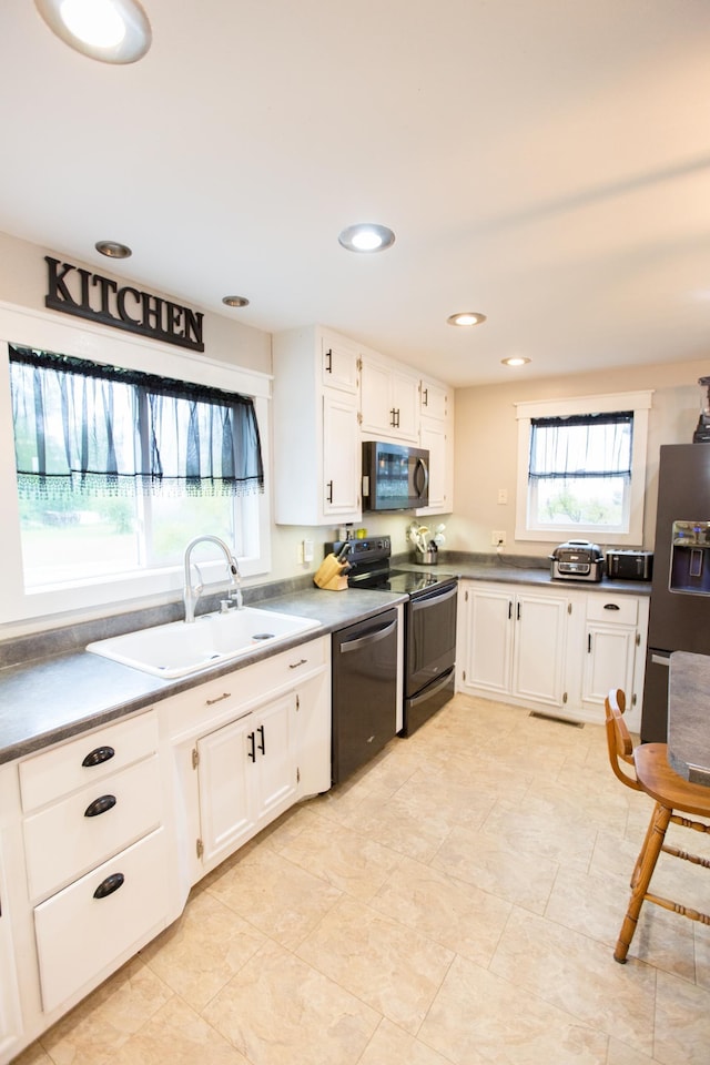 2758 220th St, Madison, MN 56256 - kitchen with range with electric stovetop, stainless steel dishwasher, a sink, fridge with ice dispenser, and white cabinetry