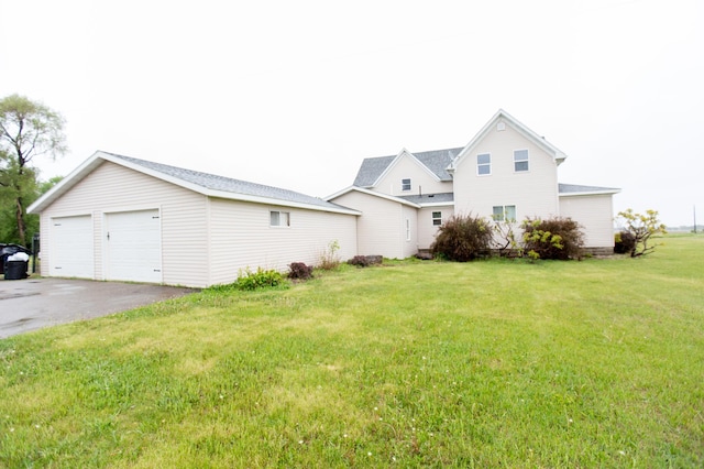 2758 220th St, Madison, MN 56256 - view of front of house with a detached garage, an outbuilding, and a front lawn