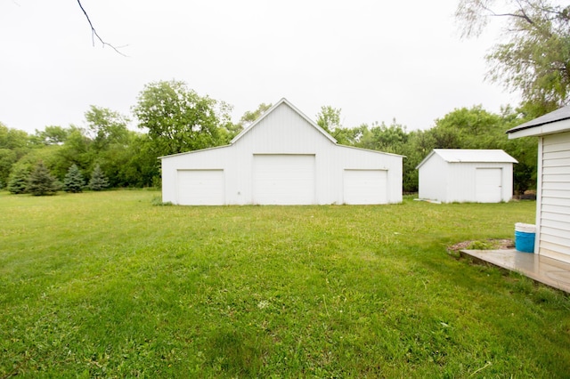 2758 220th St, Madison, MN 56256 - view of green lawn with a garage and an outbuilding